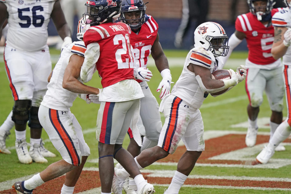 Auburn running back Shaun Shivers (8) sprints past Mississippi defenders on his way to a one-yard touchdown during the second half of an NCAA college football game in Oxford, Miss., Saturday, Oct. 24, 2020. (AP Photo/Rogelio V. Solis)