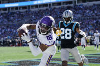 Minnesota Vikings wide receiver Justin Jefferson (18) makes the catch but out of bounds for a two-point conversion against Carolina Panthers cornerback Keith Taylor (28) during the second half of an NFL football game, Sunday, Oct. 17, 2021, in Charlotte, N.C. (AP Photo/Gerald Herbert)