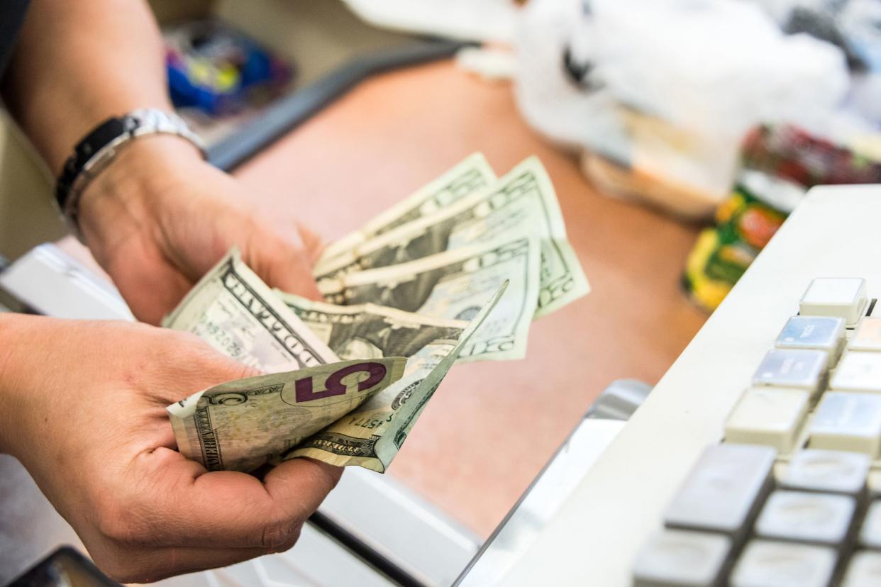 cashier hands counting cash