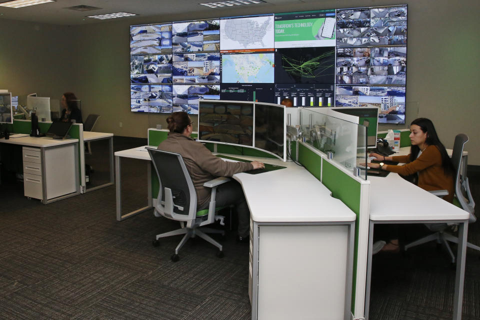 Paycom personnel monitor physical and IT security in the command center at the Oklahoma City Paycom campus Monday, Nov. 25, 2019, in Oklahoma City. Company officials say they ramped-up security after a disgruntled ex-worker began frightening employees with threatening messages and social media posts. (AP Photo/Sue Ogrocki)