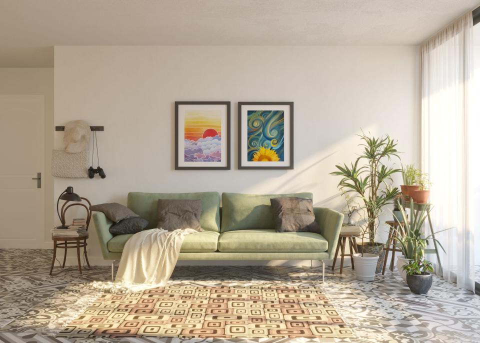 Green midcentury modern couch below artwork in white living room