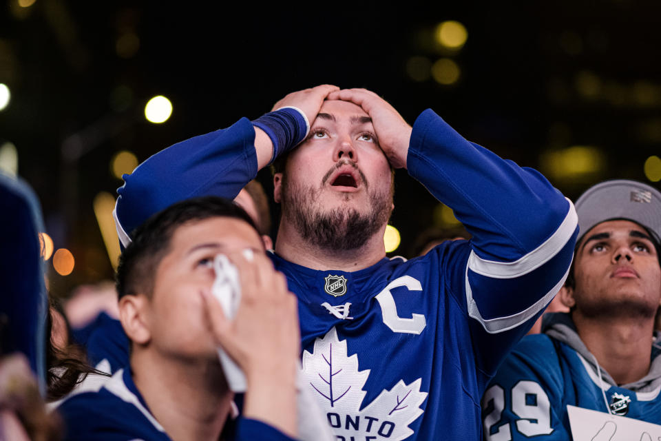 Fans react during Game 7 of an NHL hockey first-round playoff series between the Toronto Maple Leafs and the Tampa Bay Lightning in Toronto, Saturday May 14, 2022. (Christopher Katsarov/The Canadian Press via AP)