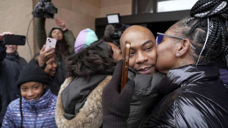 Marvin Haynes, 35, is hugged by supporters as he walks out of the Minnesota Correctional Facility at Stillwater in Bayport, Minn. on Monday, Dec. 11, 2023, after a judge set aside his murder conviction in the 2004 killing of a man at a Minneapolis flower shop. Haynes was 16 when Randy Sherer, 55, was killed during a robbery. (AP Photo/Mark Vancleave)