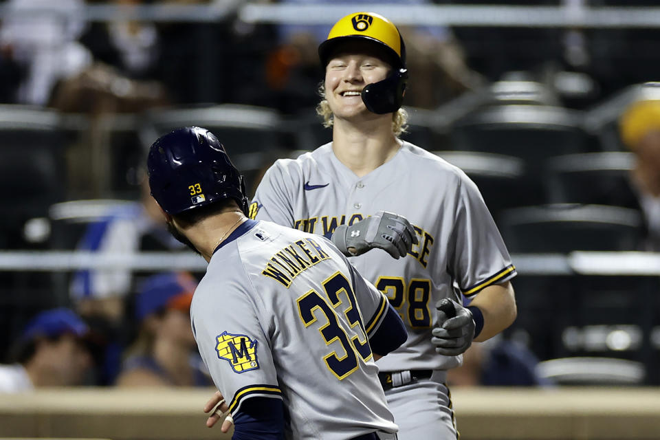 Milwaukee Brewers' Joey Wiemer, right, is congratulated by Jesse Winkmer (33) after hitting a two-run home run during the sixth inning of a baseball game against the New York Mets, Monday, June 26, 2023, in New York. (AP Photo/Adam Hunger)