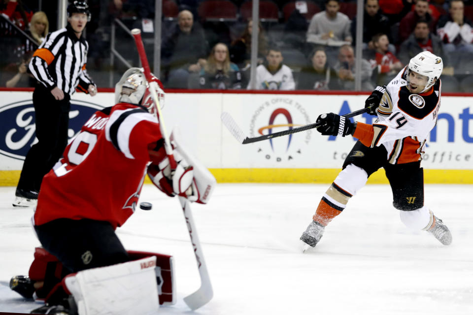 FILE - In this Dec. 18, 2019, file photo, Anaheim Ducks center Adam Henrique (14) scores a goal against New Jersey Devils goaltender Mackenzie Blackwood (29) during the first period of an NHL hockey game in Newark, N.J. Linemates Henrique and Jakob Silfverberg bucked their team's offensive struggles with a pair of impressive seasons, and they will be a foundation of the rebuilding effort. Henrique was particularly productive, leading the roster with 43 points. They are both locked into long-term contracts .(AP Photo/Kathy Willens, File)