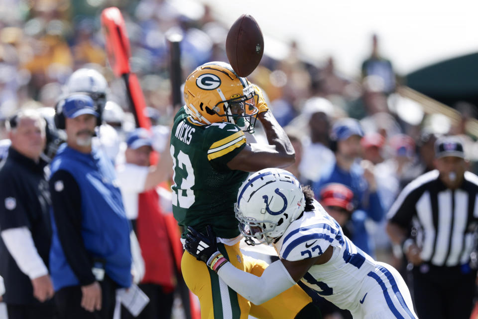 Indianapolis Colts cornerback Kenny Moore II (23) breaks up a pss intended for Green Bay Packers wide receiver Dontayvion Wicks (13) during the first half of an NFL football game Sunday, Sept. 15, 2024, in Green Bay, Wis. (AP Photo/Matt Ludtke)