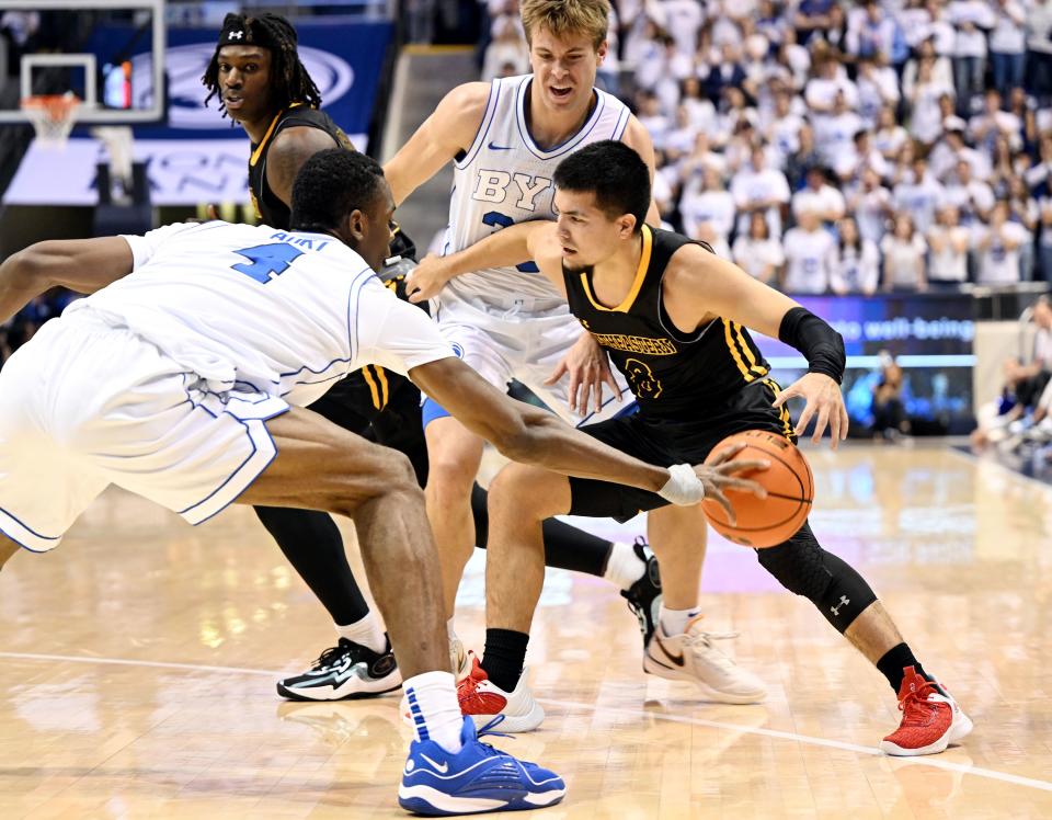 Brigham Young Cougars forward Atiki Ally Atiki (4) knocks the ball away from Southeastern Louisiana Lions guard Carlos Paez (8) as BYU and SE Louisiana play at the Marriott Center in Provo on Wednesday, Nov. 15, 2023. | Scott G Winterton, Deseret News