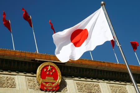 Japan's flag flutters outside the Great Hall of the People before a welcome ceremony for Japanese Prime Minister Shinzo Abe in Beijing