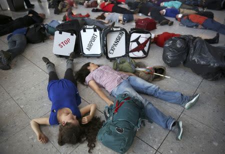 Climate activist group Reclaim the Power lie on the ground during a protest against airport expansion plans at Heathrow Airport in London, Britain October 1, 2016. REUTERS/Neil Hall