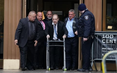 Harvey Weinstein leaves Manhattan Criminal Court, using a walker, following a hearing in New York. - A woman who alleges disgraced Hollywood mogul Harvey Weinstein sexually assaulted her when she was 16 filed suit against him on December 19, 2019 and rejected a settlement reached by other accusers.  - Credit: AFP