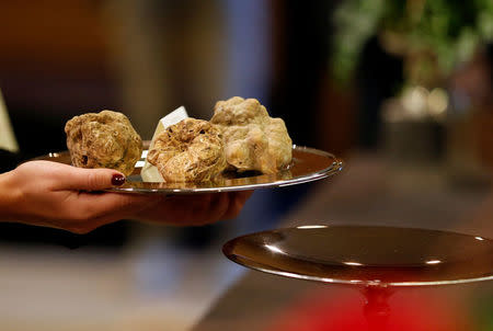 Hostess carries a set of truffles weighing 450 grams during the international auction for truffles at the Grinzane Castle in Grinzane Cavour near Alba, Italy, November 12, 2017. REUTERS/ Stefano Rellandini