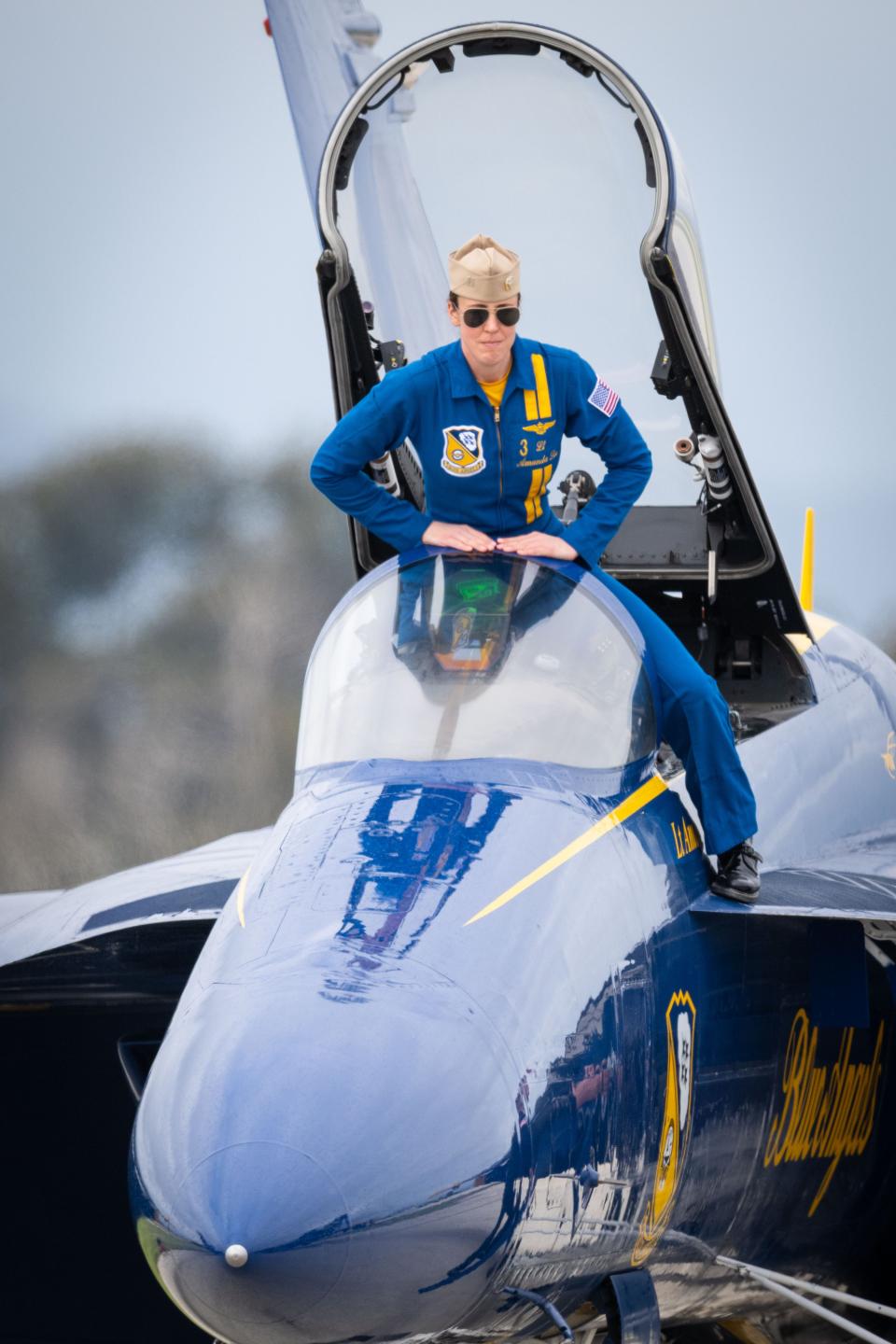 U.S. Navy Blue Angels pilot Lt. Amanda Lee climbs into the cockpit of her F/A-18E Super Hornet jet before a practice session at Naval Base Ventura County, Point Mugu in California on March 16, 2023.