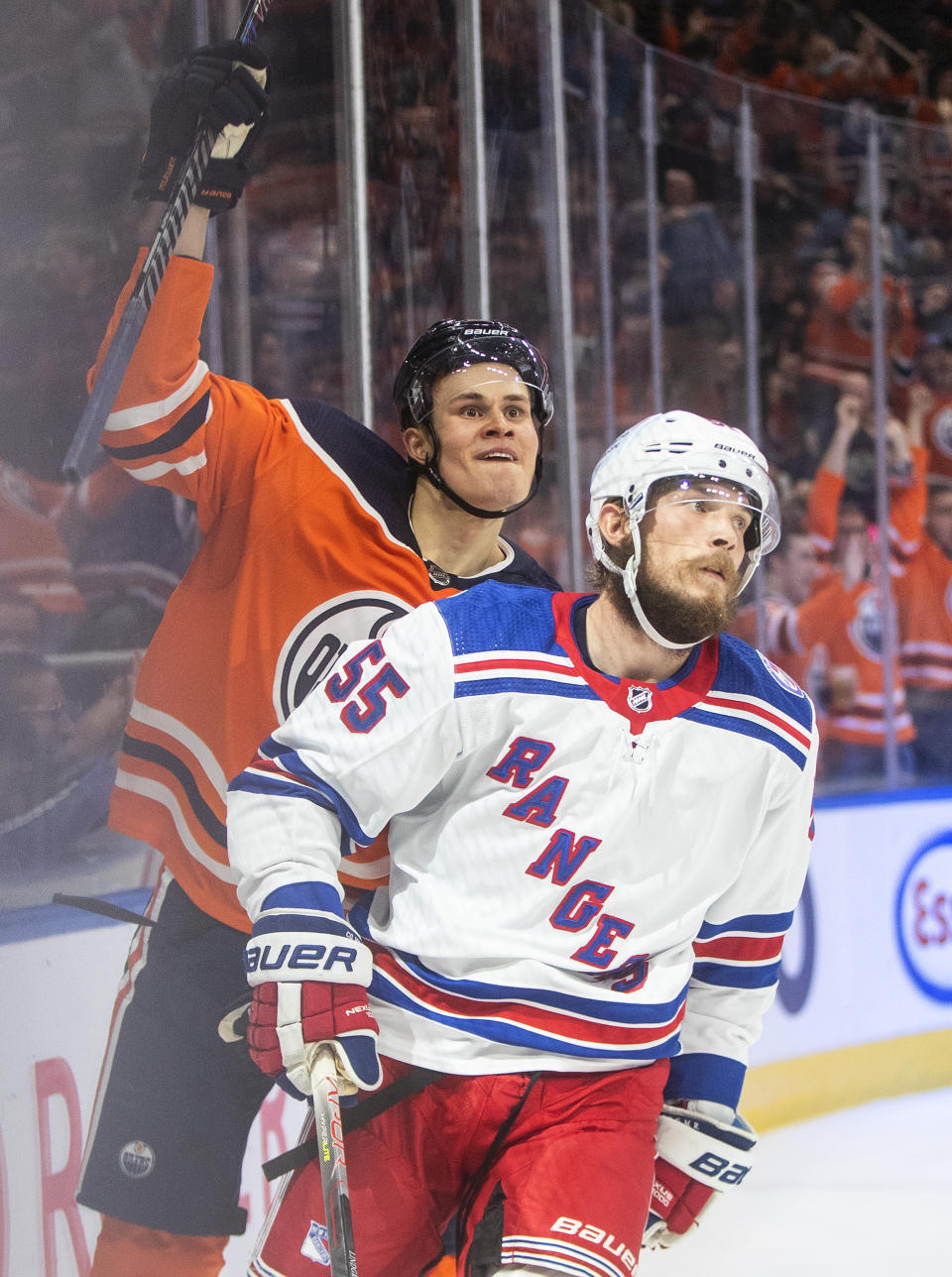 New York Rangers' Ryan Lindgren (55) looks on as Edmonton Oilers' Jesse Puljujarvi (13) celebrates a goal during second-period NHL hockey game action in Edmonton, Alberta, Friday, Nov. 5, 2021. (Jason Franson/The Canadian Press via AP)