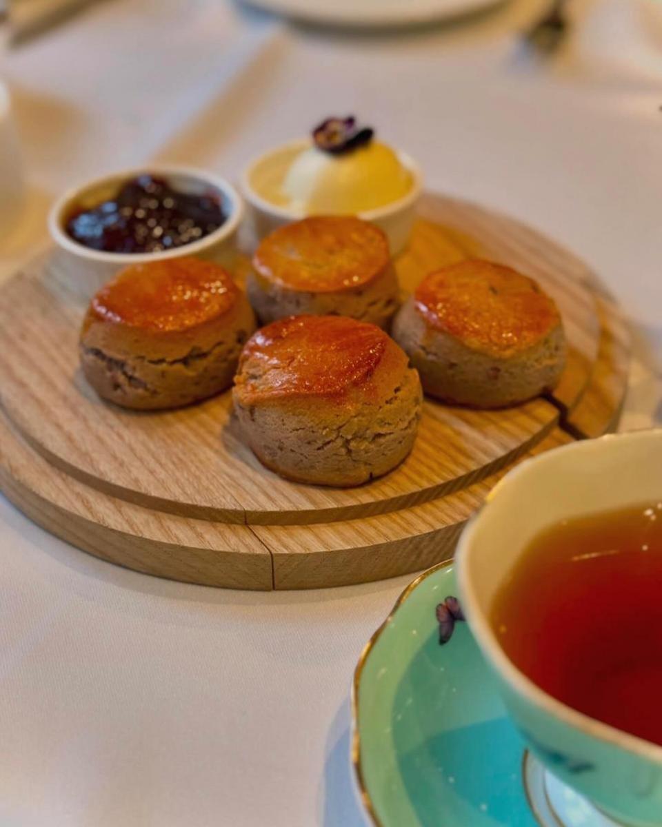 News Shopper: Freshly baked wild berry scones were served with rose jam and cream, lychee syrup and drizzled with lavender honey.