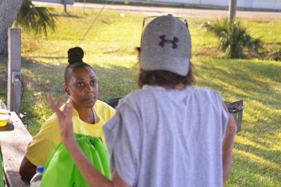 Volunteer Rachel Smith intertviews a woman at Sand Point  Park in Titusville. Monday was the Point-in-Time count, where volunteers and organizations go out in the community and count the homeless. 