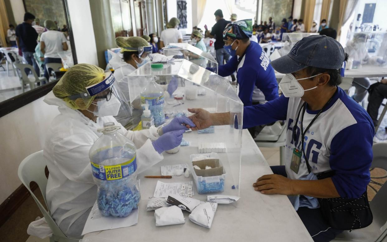 City workers in the Philippines are screened for coronavirus with rapid antibody tests - Shutterstock