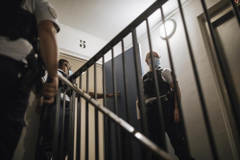 Police officers patrol in the Paris suburb of Sarcelles, Tuesday, June, 15, 2021. Officers say that as well as fighting crime, their job involves a lot of social work, everything from helping parents discipline unruly children to assisting families with medical or other emergencies. Here, police were responding to a family's call about a man diagnosed as schizophrenic who had neglected to take his treatment and was said to be wandering around with a knife. Officers, some with stun guns drawn, searched through the halls and stairwells of the man's tower block for him, but were unable to track him down. (AP Photo/Lewis Joly)