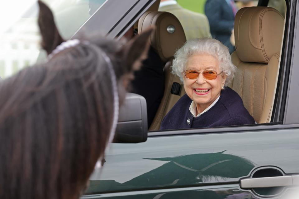 Queen Elizabeth smiles as she looks at one of the horses part of  The Royal Windsor Horse Show.