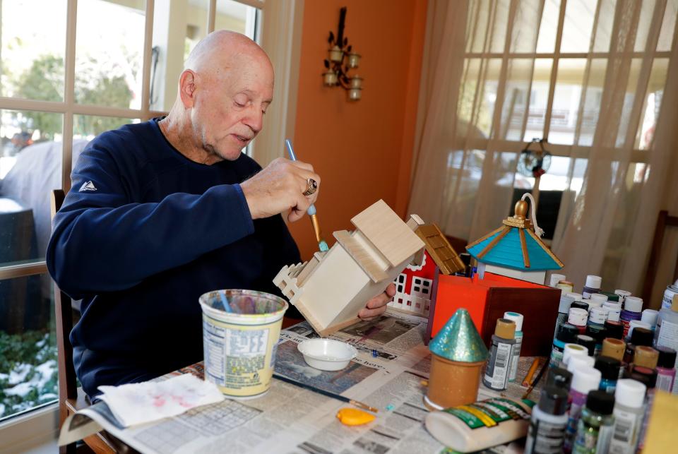 Darryl Johnson, a Vietnam War veteran who battled post-traumatic stress disorder, paints birdhouses at his home on March 1 in Allouez, Wis. Johnson found art to be therapeutic while working through his PTSD.