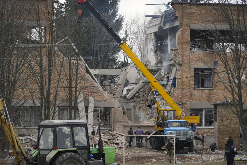 Emergency personnel work at the scene following a drone attack in the town of Rzhyshchiv, Kyiv region, Ukraine, Wednesday, March 22, 2023. (AP Photo/Efrem Lukatsky)