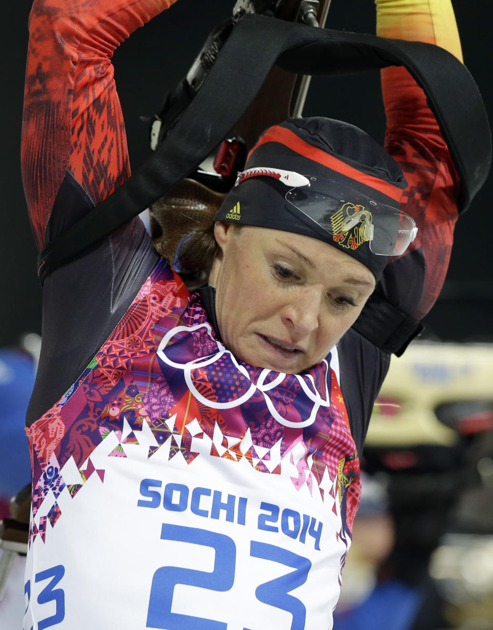 Germany's Evi Sachenbacher-Stehle holds his rifle during the women's biathlon 12.5k mass-start, at the 2014 Winter Olympics, Monday, Feb. 17, 2014, in Krasnaya Polyana, Russia. (AP Photo/Lee Jin-man)