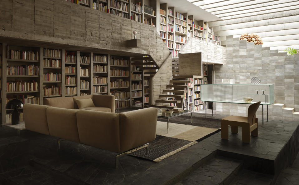 The house designed by sculptor Pedro Reyes in Mexico City features a double-height library with concrete shelves and stairs.