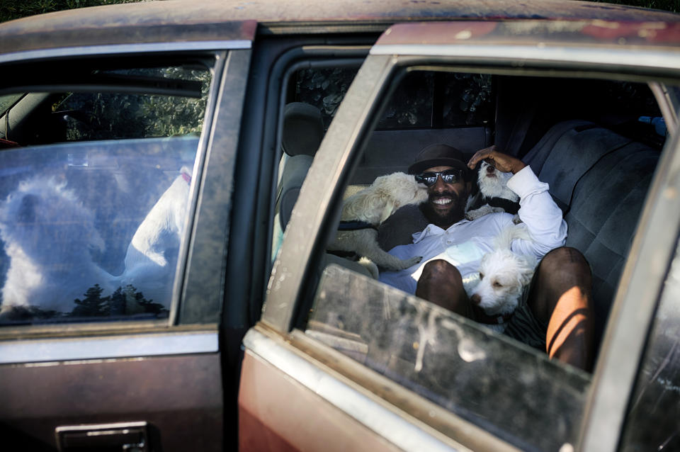 David Clarke who is suffering homelessness and living in his car with his 6 dogs, takes to the shade at the Sepulveda Basin dog park in Los Angeles on Tuesday, July 9, 2024. Dozens of locations in the West and Pacific Northwest tied or broke previous heat records over the weekend and are expected to keep doing so into the week. (AP Photo/Richard Vogel)