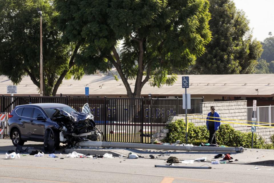 A resident surveys the crash scene, where Los Angeles County sheriff's cadets were injured