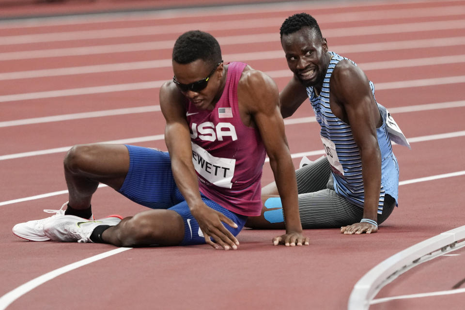 Isaiah Jewett, of the United States, and Nijel Amos, right, of Botswana, fall in the men's 800-meter semifinal at the 2020 Summer Olympics, Sunday, Aug. 1, 2021, in Tokyo. (AP Photo/Jae C. Hong)