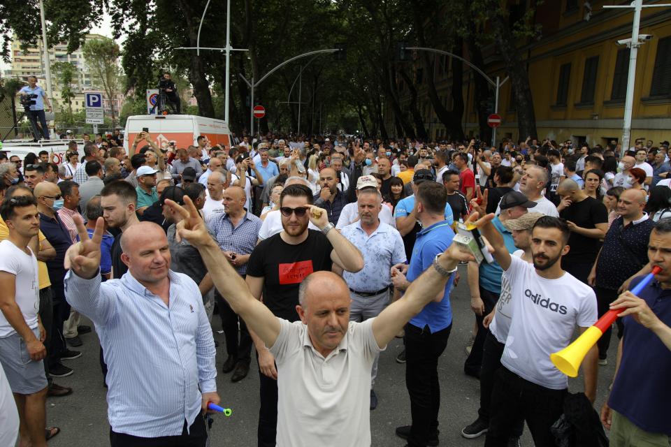 Protesters gather during a rally against the demolition of the national theater building as in Tirana, Monday, May 18, 2020. Albanian artists and opposition party supporters gathered for a second day Monday to protest the demolition of the crumbling National Theater building in the capital, which has triggered strong political tension amid a major heritage debate. (AP Photo/Gent Onuzi)