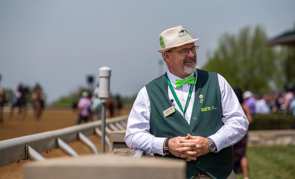 Greg Burke leans on the rail near the clubhouse on the Keenland grounds on Thursday afternoon. Burke is one of several 'Betologists' on staff that help racegoers get the most of their experience by offering betting advice, directions around the track and a familiar, welcoming smile. April 21, 2023