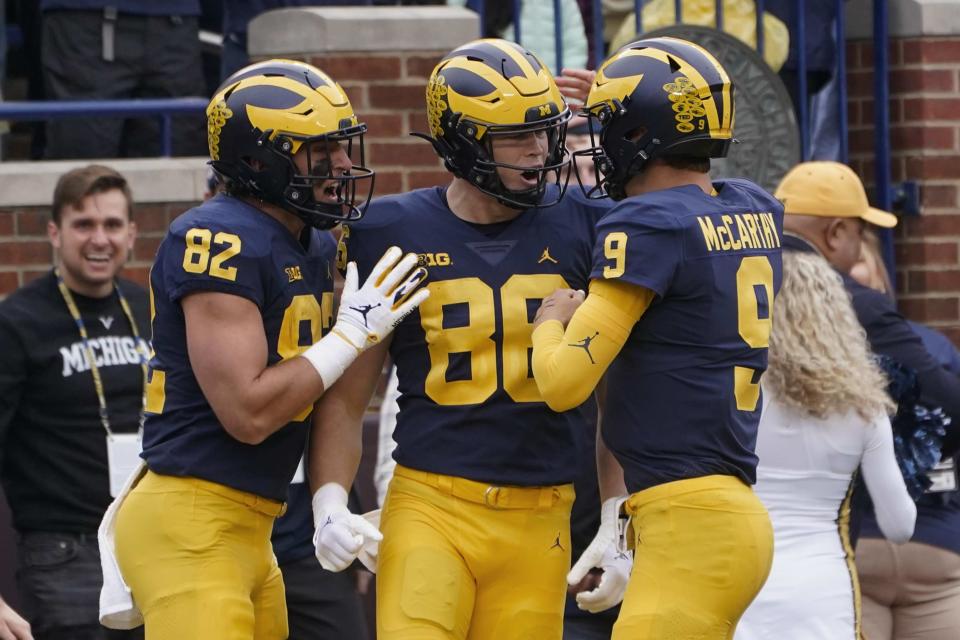 Michigan tight end Luke Schoonmaker (86) celebrates his touchdown reception with Max Bredeson (82) and J.J. McCarthy (9) in the first half of an NCAA college football game against Maryland in Ann Arbor, Mich., Saturday, Sept. 24, 2022. (AP Photo/Paul Sancya)