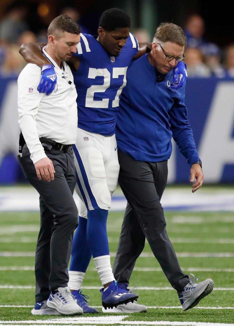 Indianapolis Colts cornerback Xavier Rhodes (27) is helped off the field after an injury Sunday, Jan. 2, 2022, during a game against the Las Vegas Raiders at Lucas Oil Stadium in Indianapolis.