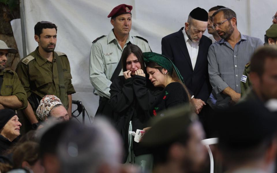 Relatives mourn during the funeral ceremony of Israeli IDF reservist soldier