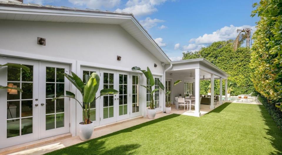 A t 231 El Dorado Lane in Palm Beach, a covered loggia faces the rear lawn  and, at the rear, the swimming pool. The property just sold for a recorded $9.55 million.