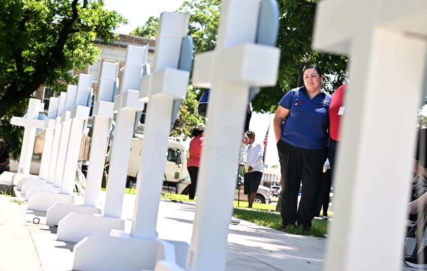 Uvalde, Texas May 26, 2022- Mourners visit a memorial for the victims of a mass shooting in Uvalde, Texas. Nineteen students and two teachers died when a gunman opened fire in a classroom Tuesday. (Wally Skalij/Los Angeles Times)