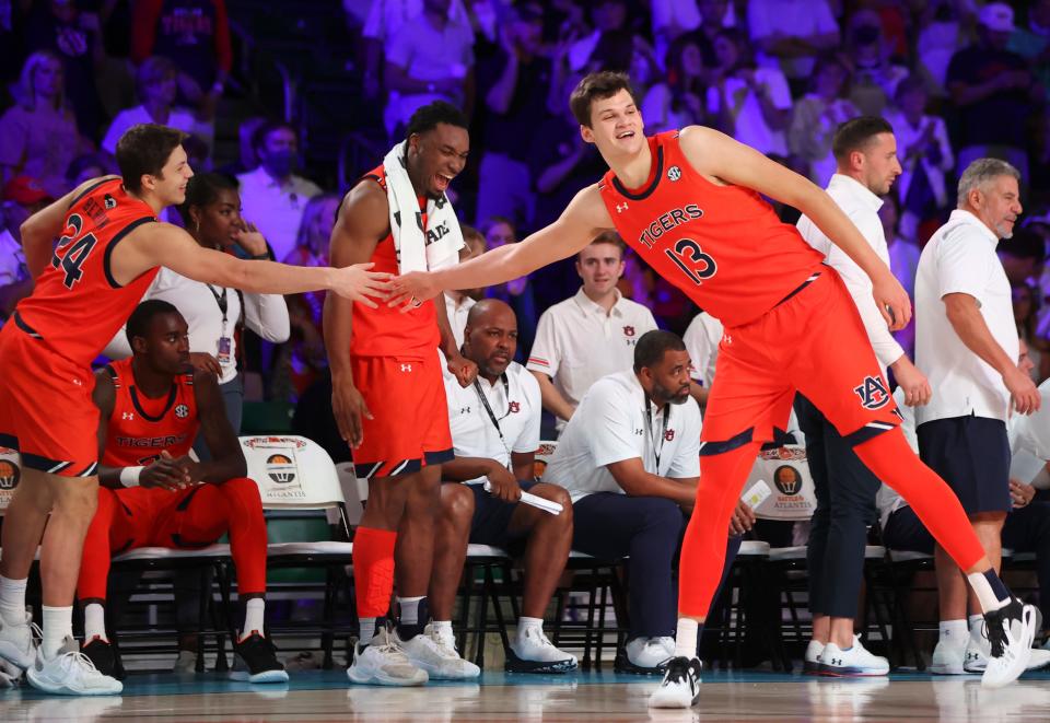 Nov 25, 2021; Nassau, BHS; Auburn Tigers forward Walker Kessler (13) celebrates with guard Lior Berman (24) against the Loyola Ramblers during the second half in the 2021 Battle 4 Atlantis at Imperial Arena. Mandatory Credit: Kevin Jairaj-USA TODAY Sports