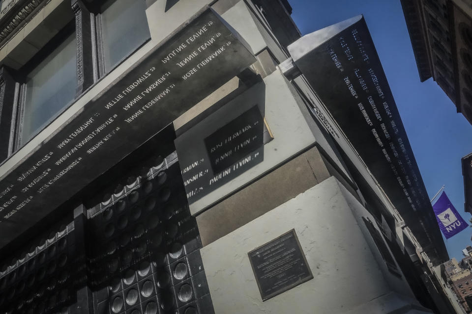 A metal overhang section of the Triangle Shirtwaist Memorial, engraved with names, wraps the first story of New York University's biology building, Tuesday Oct. 10, 2023, in New York. The building is the site where 146 people, mostly immigrant girls and women, were killed in a 1911 clothing factory fire. (AP Photo/Bebeto Matthews)