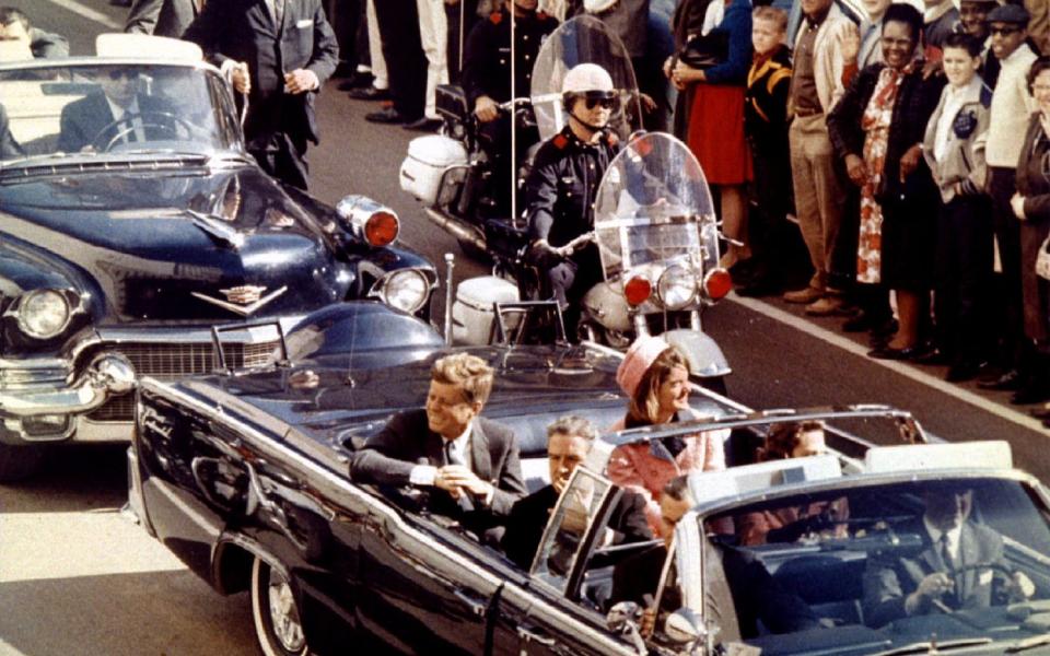 President John F. Kennedy, Jaqueline Kennedy and Texas Governor John Connally ride in a liousine moments before Kennedy was assassinated, in Dallas - Reuters
