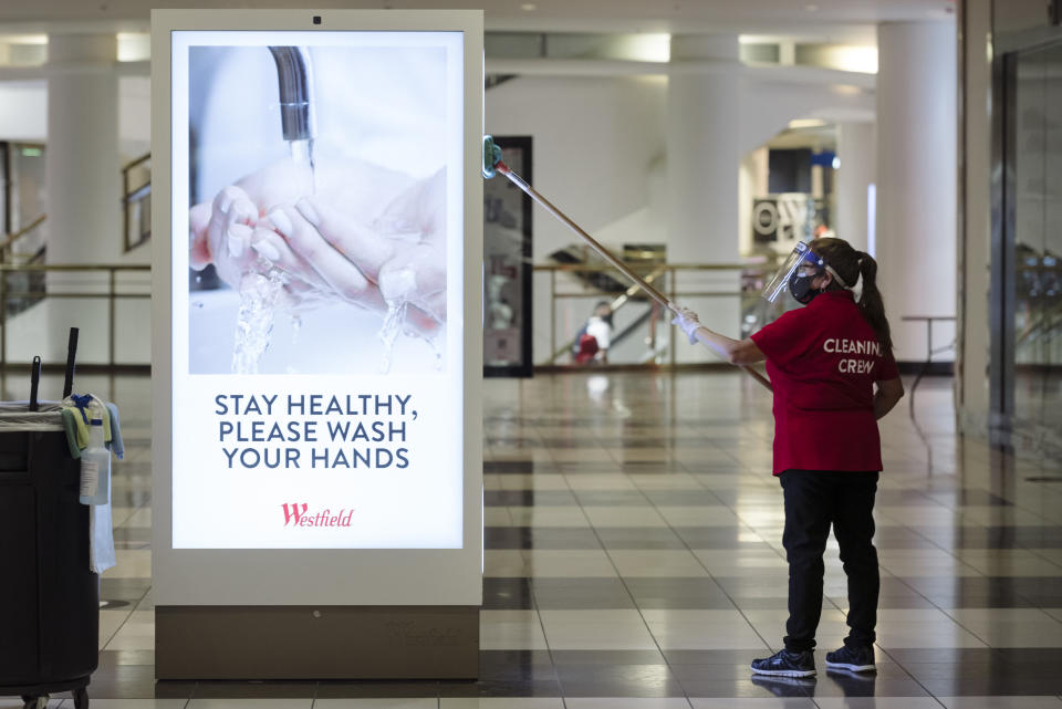 A cleaning crew member cleans a kiosk at Westfield San Francisco Centre in San Francisco, California, U.S., on Thursday, June 18, 2020. (Michael Short/Bloomberg via Getty Images)