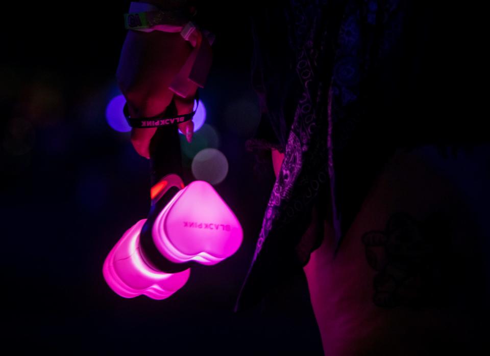 A fan holds a BLACKPINK heart hammer as the group performs Saturday on the Coachella Stage during the Coachella Valley Music and Arts Festival at the Empire Polo Club in Indio.