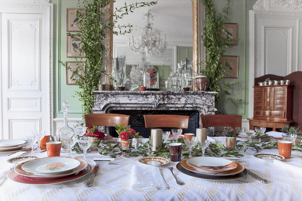 <p>Small floral arrangements, eucalyptus, and silver pillar candles make a for a festive centerpiece that doesn't disrupt your view of company. </p>