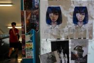 Posters of a girl wearing an eye patch, a symbol of the fight for freedom after a young woman sustained a severe eye injury during an anti-government protest, stands as part of a newly created Lennon Wall, in Hong Kong, Saturday, Sept. 28, 2019. Hong Kong activists first created their own Lennon Wall during the 2014 protests, covering a wall with a vibrant Post-it notes calling for democratic reform. Five years later, protestors have gathered to create impromptu Lennon Walls across Hong Kong island. (AP Photo/Vincent Yu)