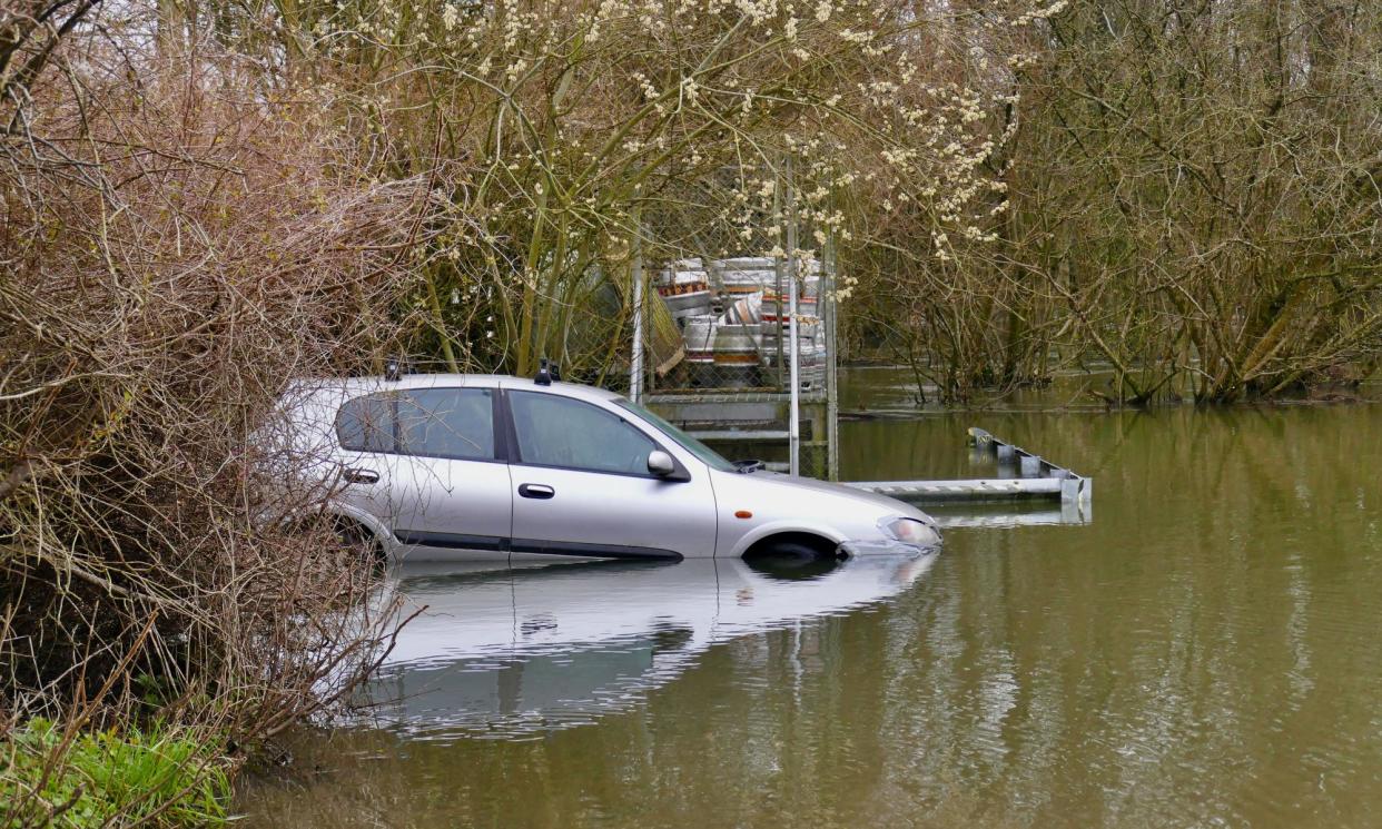 <span>A car submerged in a flooded pub car park in Playhatch, Oxfordshire.</span><span>Photograph: Geoffrey Swaine/REX/Shutterstock</span>