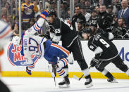 Los Angeles Kings center Quinton Byfield (55) pushes Edmonton Oilers center Connor McDavid (97) during the second period of Game 4 of an NHL hockey Stanley Cup first-round playoff series hockey game Sunday, April 23, 2023, in Los Angeles. (AP Photo/Ashley Landis)