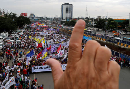 An activist gestures a "Laban" (Fight) sign as they march near the House of Representatives to protest President Rodrigo Duterte's State of the Nation address in Quezon city, Metro Manila, Philippines July 23, 2018. REUTERS/Erik De Castro