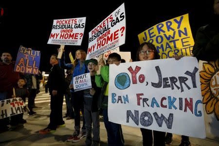 People hold signs as they rally for the permanent shut down of the Aliso Canyon natural gas storage facility near the Porter Ranch neighborhood in Los Angeles, California February 19, 2016. REUTERS/Mario Anzuoni