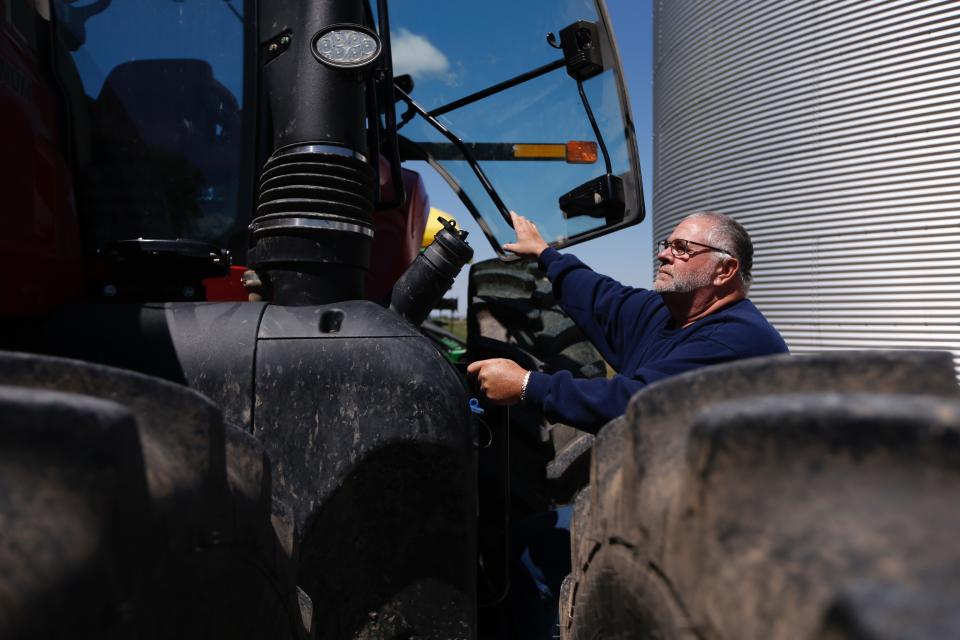 Bret Davis, a soybean farmer, prepares to climb into his tractor in Delaware, Ohio, on Tuesday, May 14, 2019. Some farmers fear the protracted trade war with China will permanently alter their sales, leaving them without a foothold in one of their largest markets. (AP Photo/Angie Wang)