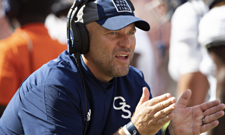 Former Georgia Southern head coach Chad Lunsford claps his hands on the sidelines.