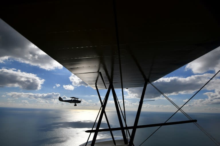 A Tiger Moth flies alongside a Travel Air 4000 biplane during a photocall for the launch of the Vintage Air Rally -- from Crete to Cape Town -- in Shoreham-by-Sea, southern England on October 10, 2016